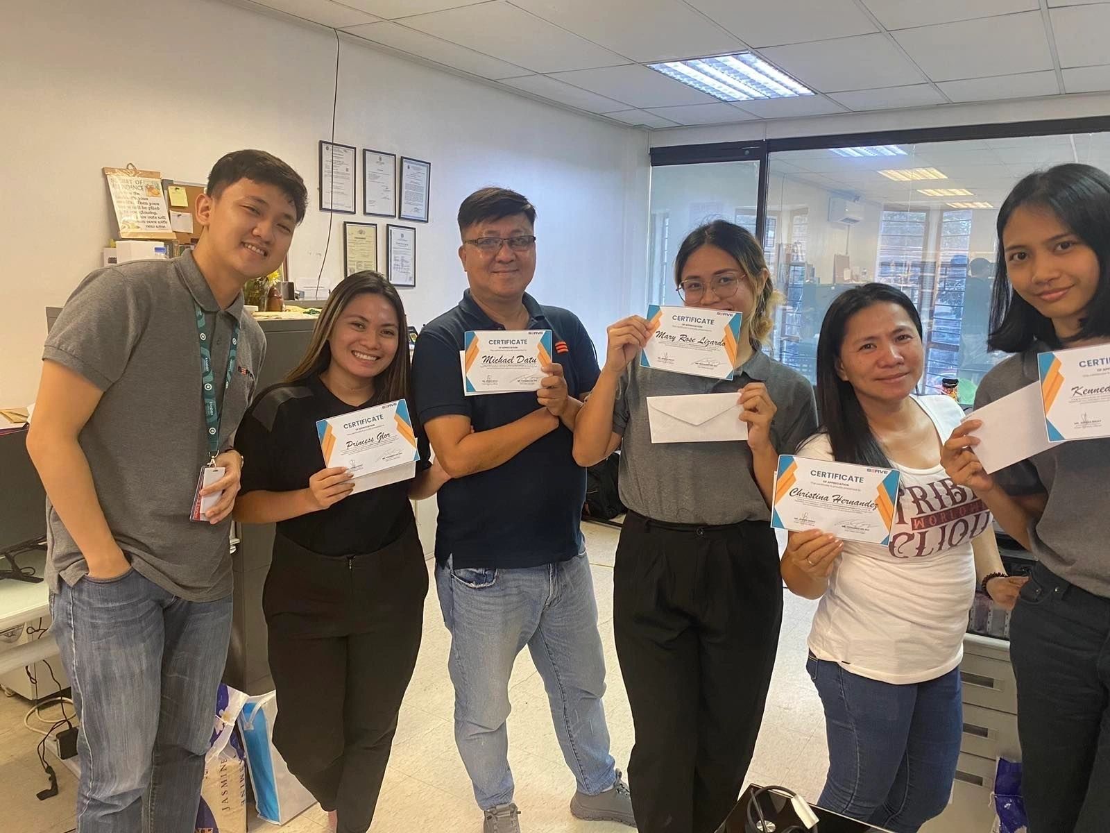 SERVE team members receiving employee recognition certificates